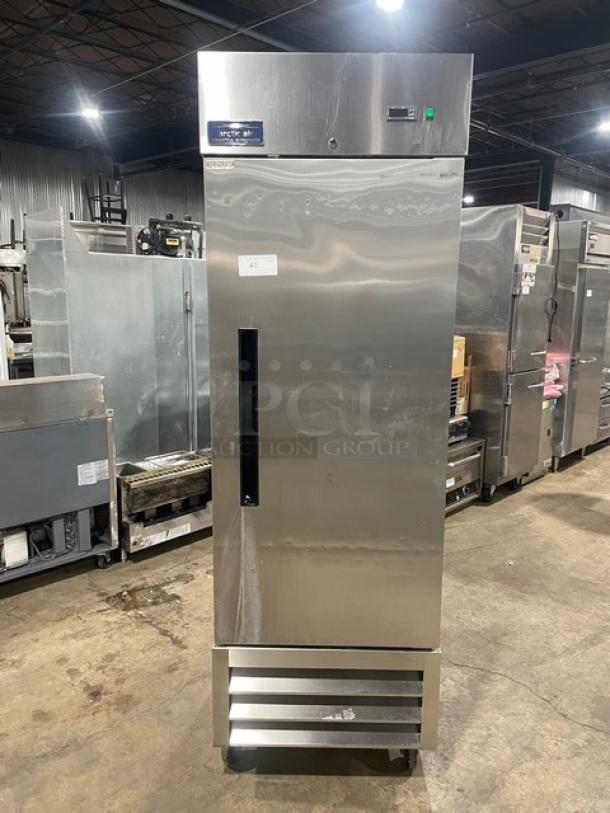 Arctic Air AR23E stainless steel single door refrigerator, Energy Star certified, with poly-coated wired rack, on casters.