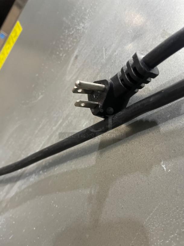 Close-up of a power cord and plug for the Arctic Air Commercial Stainless Steel Refrigerator, Model AR23E.