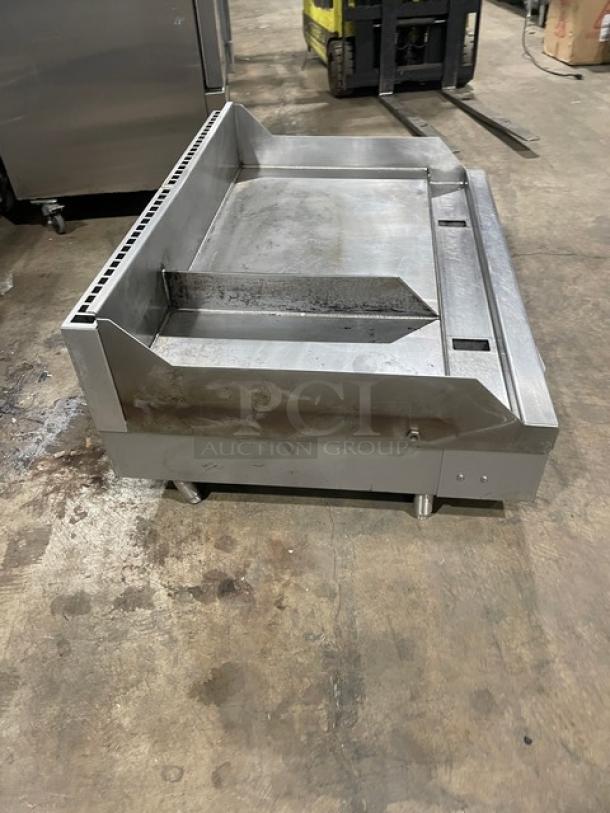 WoodStone commercial stainless steel gas plancha griddle, split-top, with back and side splash. On legs, used condition.