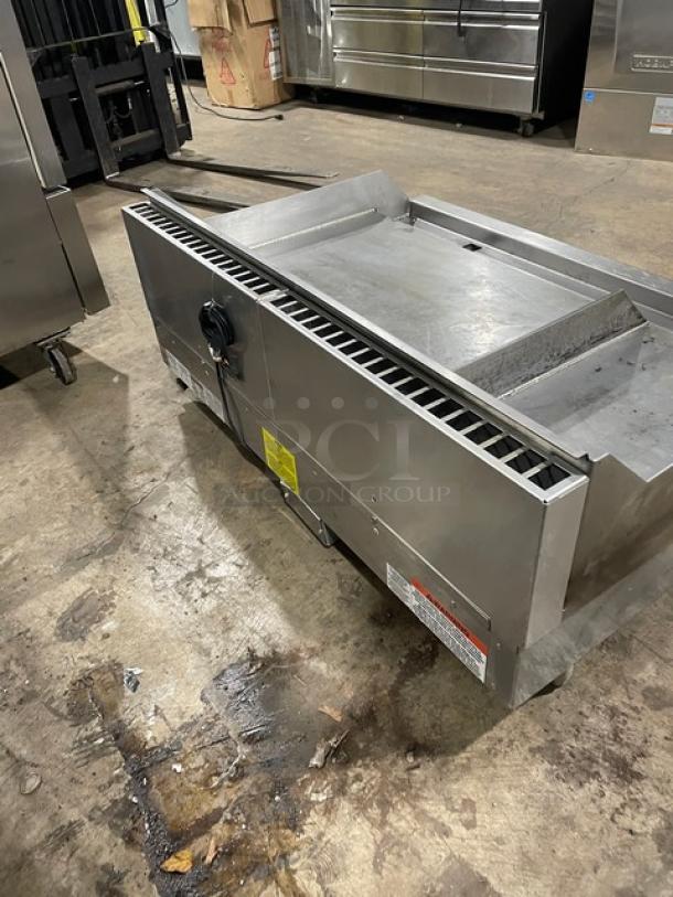 WoodStone commercial stainless steel gas-powered split-top plancha flat griddle with back and side splash, on legs.