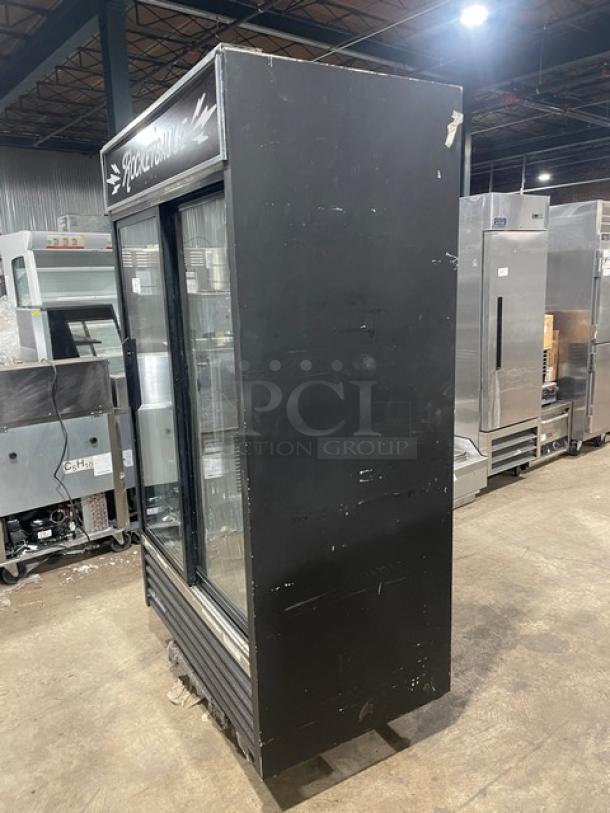True GDM-41 commercial black double glass sliding door reach-in merchandiser refrigerator with bottle organizer, 115V, used condition.