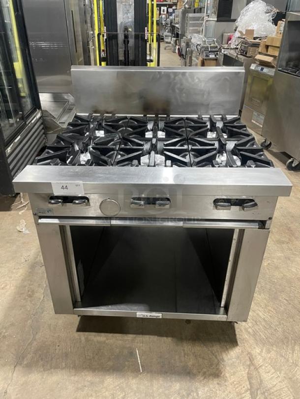 U.S. Range stainless steel gas-powered 6-burner range with backsplash, enclosed storage base, on casters, like new condition.