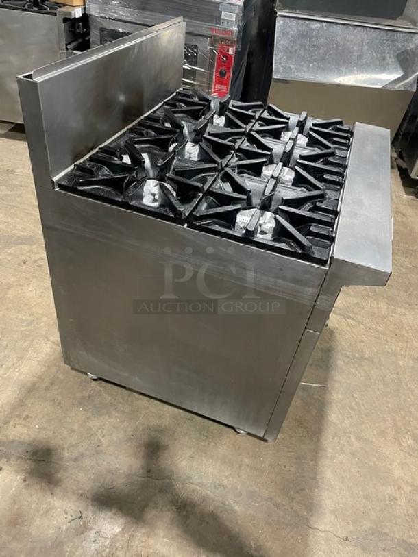 U.S. Range stainless steel 6-burner gas range with back splash, enclosed dry storage base, and casters. Good condition.