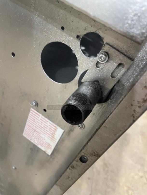 U.S. Range gas-powered 6-burner range, stainless steel, with backsplash, cabinet-style storage, on casters. Visible connections.