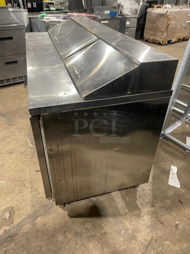Beverage-Air Elite Series 3-door refrigerated prep table, stainless steel, Model SPE72-18, on casters, condition: used.