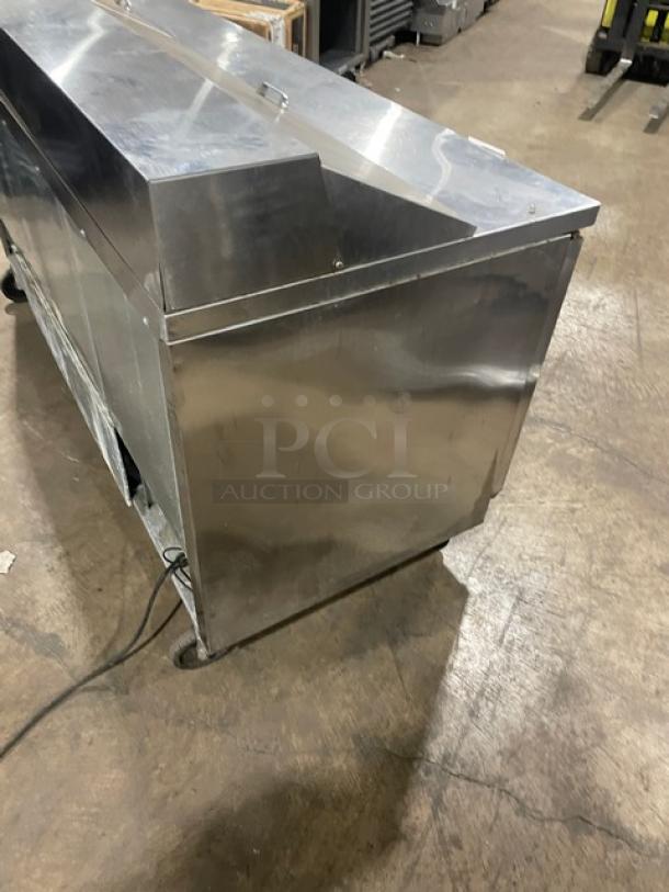 Beverage-Air Elite Series 3-door stainless steel refrigerated prep table, model SPE72-18, with casters and poly-coated rack.