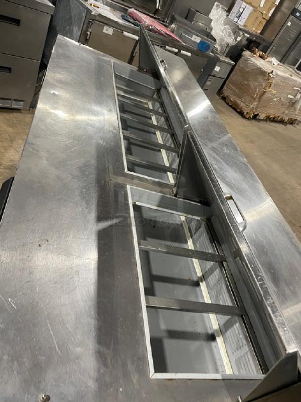 Beverage-Air Elite Series 3-door refrigerated prep table, stainless steel, model SPE72-18 in good condition, on casters.