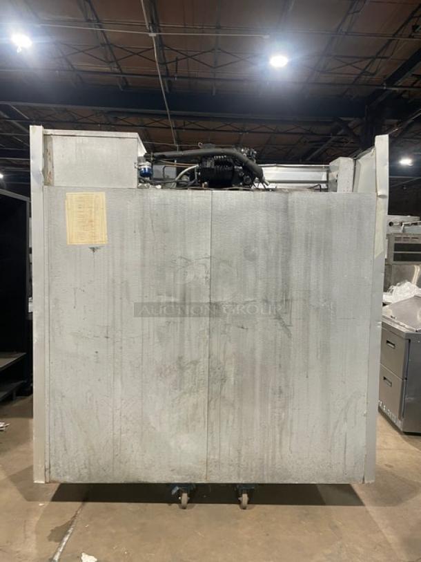 Traulsen stainless steel triple door reach-in freezer, model G31010, on casters, Energy Star certified, poly coated rack.