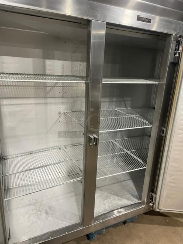 Traulsen stainless steel triple door reach-in freezer, model G31010, Energy Star certified, with poly-coated wired racks, on casters.