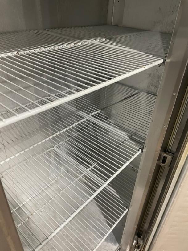 Traulsen G31010 commercial stainless steel triple door freezer with poly coated wired racks, Energy Star certified, on casters.