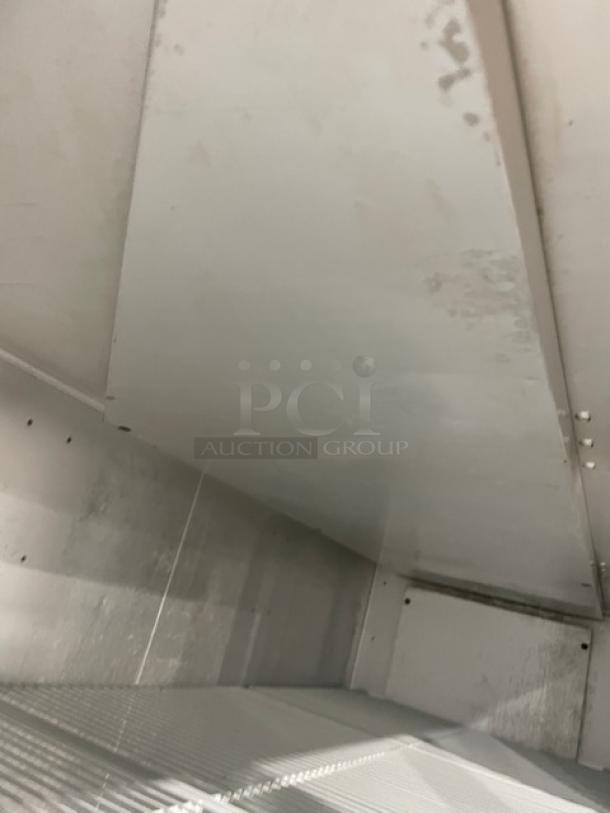 Interior of Traulsen G31010 commercial freezer, showing poly-coated wire rack. Visible wear on surfaces. Energy Star certified.