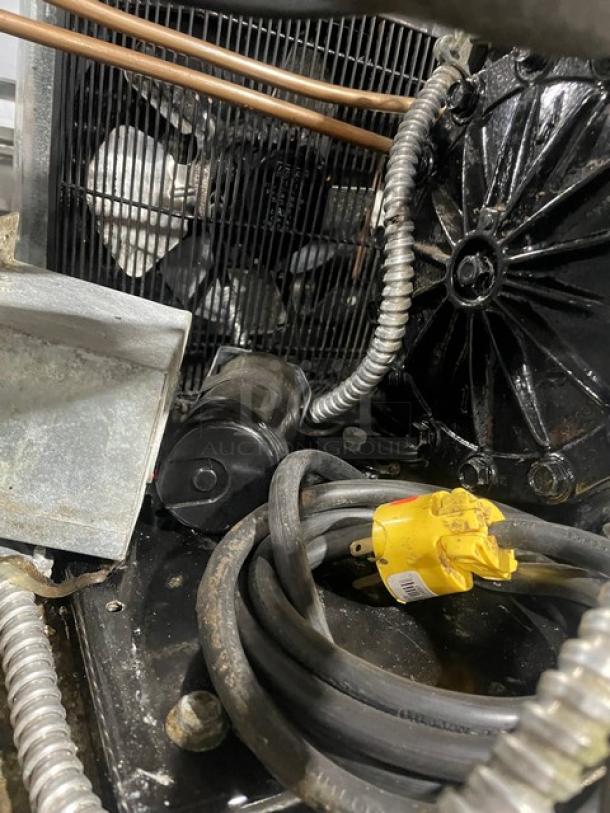 Traulsen G31010 triple door freezer internal components, showing wires and metal details. Model and energy specification unclear.