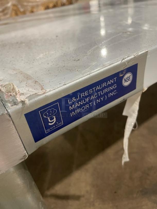 L&J stainless steel worktop table with undershelf, scratch-n-dent, on legs. Label: L&J Restaurant Manufacturing, NSF certified.