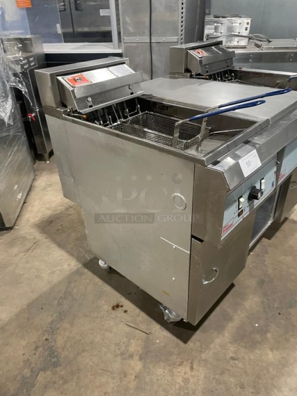 Pitco Frialator Series stainless steel 2-bay deep fat fryer with basket hanger, center pan cabinet, and casters.