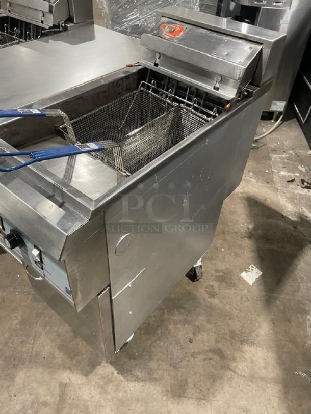 Pitco Frialator Commercial Stainless Steel 2-Bay Deep Fat Fryer System with center pan cabinet, basket hanger, fry basket, on casters.