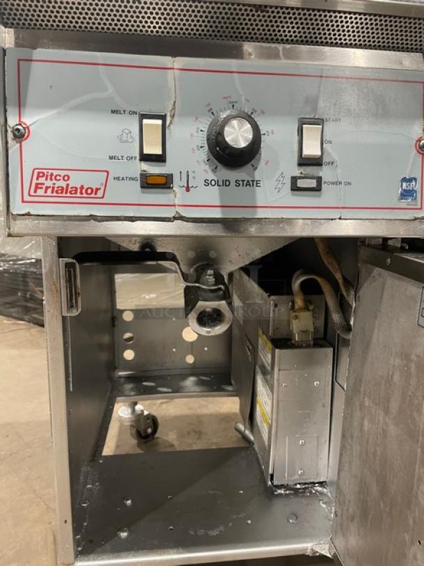 Pitco Frialator Series 2-Bay Deep Fat Fryer, stainless steel, with center pan holding cabinet, backsplash, basket hanger, and fry basket. Solid state controls, on casters, used condition.