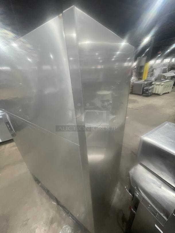 True T49G commercial stainless steel refrigerator, side view. Double glass doors, poly coated wired racks, excellent condition.