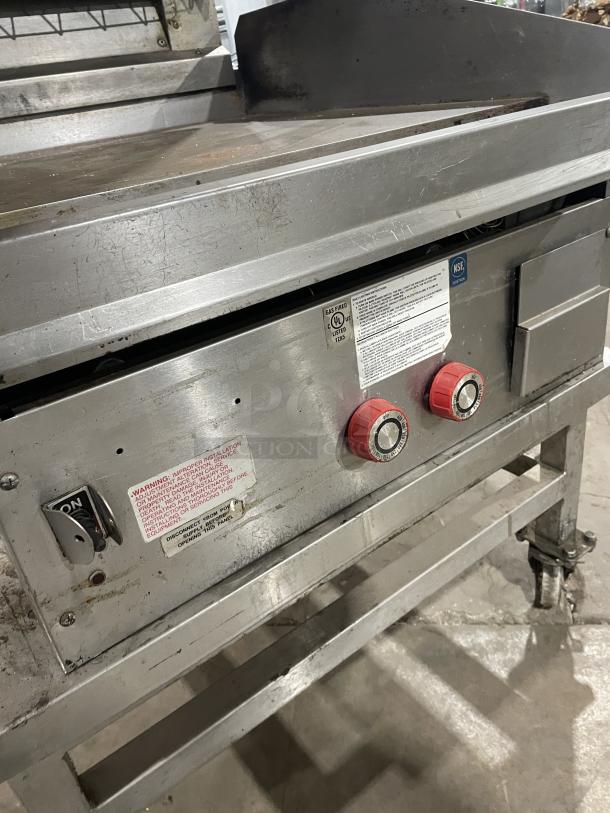 Lang 224TH-NATMG stainless steel infrared clamshell griddle on casters. Features red knobs, equipment stand, and visible labels.