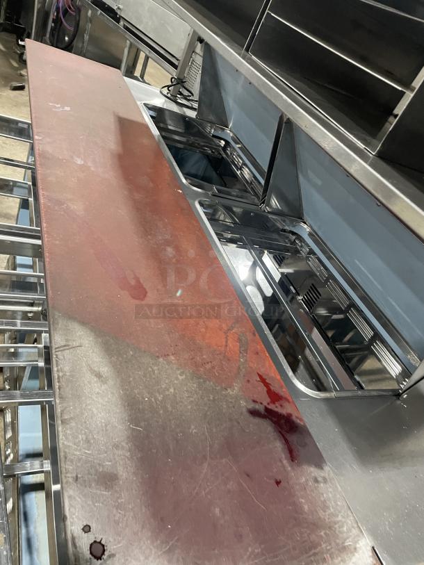 Delfield UCD4464N12DD5 stainless steel 4-drawer refrigerated prep table with overhead storage, cutting board, and bain marie.