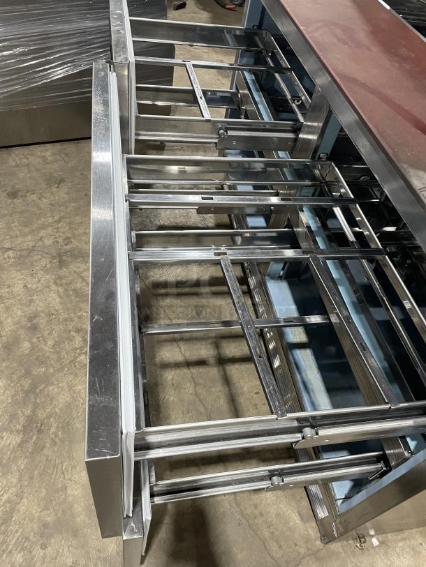 Delfield stainless steel 4-drawer refrigerated prep table with overhead storage and removable cutting board, Model UCD4464N-12-DD5.