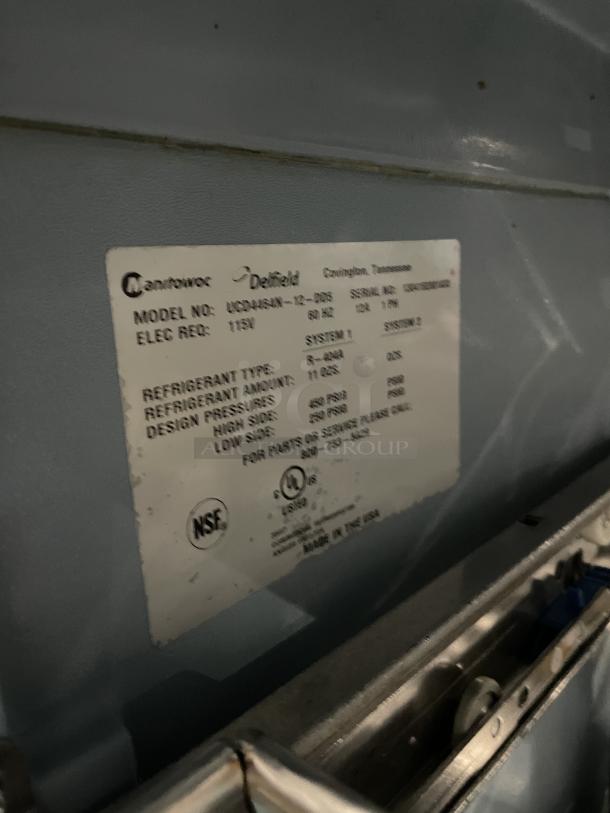 Delfield UCD4464N12DD5 stainless steel refrigerated prep table; features fridge with four drawers, overhead storage, and cutting board.