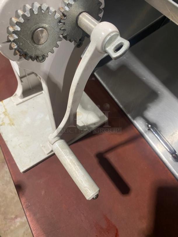 Weston Commercial White Cast Aluminum Meat Cuber/Tenderizer with crank bar, showing gears and handle, in used condition.