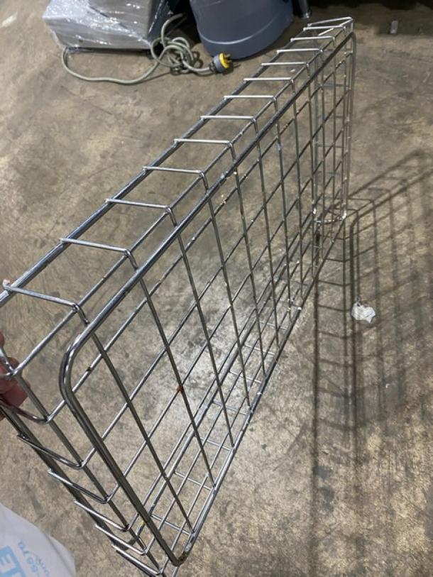 Commercial metal wired food serving tray/basket, rectangular, in used condition, showcasing a durable grid design.
