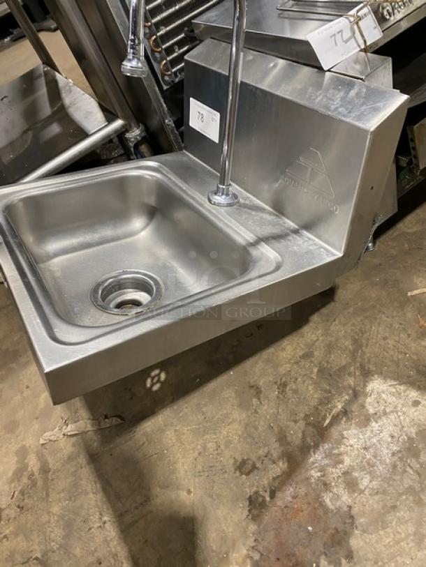 Advance Tabco commercial stainless steel wall-mounted hand sink with gooseneck faucet. Features embossed brand logo.