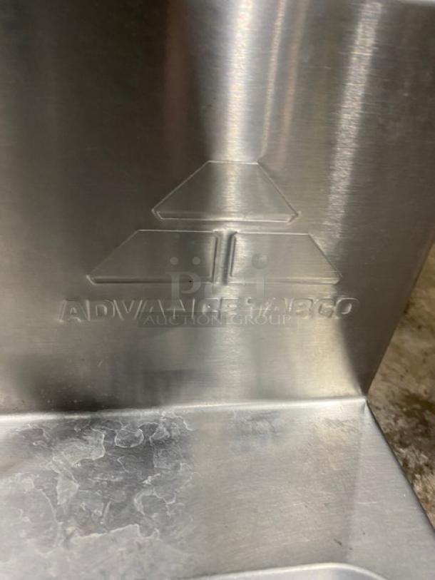 Advance Tabco stainless steel wall-mounted hand sink, featuring brand embossing. Clean surface, commercial-grade.