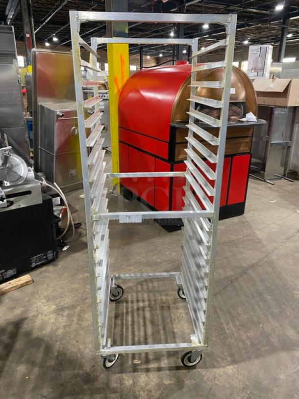 Commercial aluminum heavy-duty bun/sheet pan rack on casters, multiple slots, sturdy condition, ideal for bakery use.