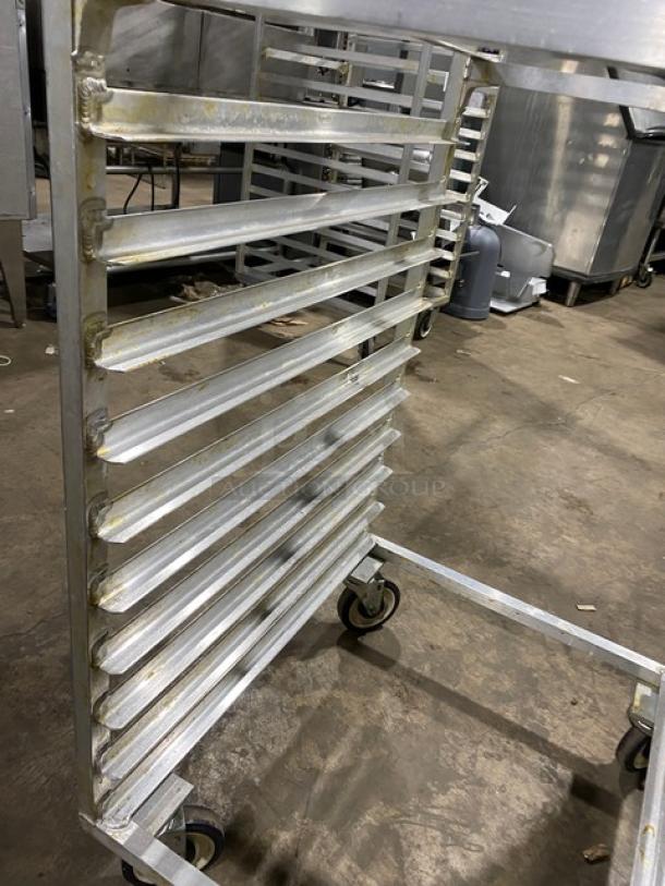 Commercial aluminum heavy-duty bun/sheet pan rack with multiple shelves and caster wheels, for easy mobility. Used condition.