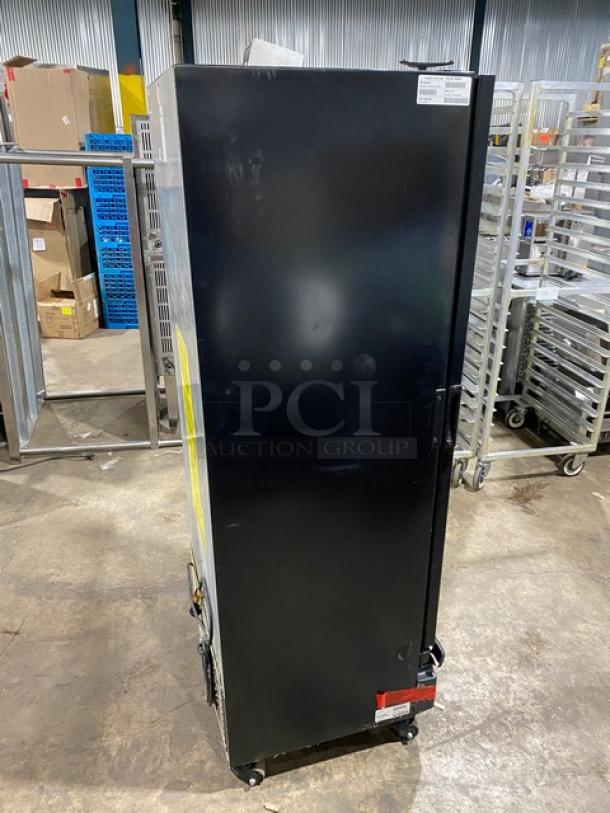Imbera VR12R2 commercial black single glass door cooler, poly coated wired rack, 115V, 1 phase, on casters, side view.