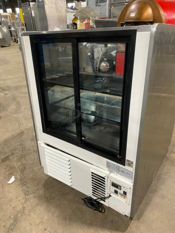 Structural Concepts Encore Series stainless steel refrigerated bakery display case, Model HV38R, with curved glass and shelving.