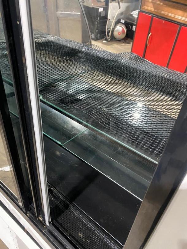 Structural Concepts Encore Series refrigerated display case, curved glass, model HV38R, stainless steel, with glass shelving, 120V 1 Phase, used condition.
