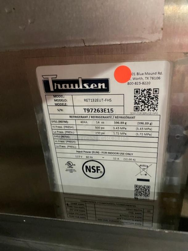 Traulsen commercial stainless steel reach-in refrigerator, model RET132EUT-FHS, with adjustable shelving, on casters, 115V. Serial number T97263E15. NSF certified.