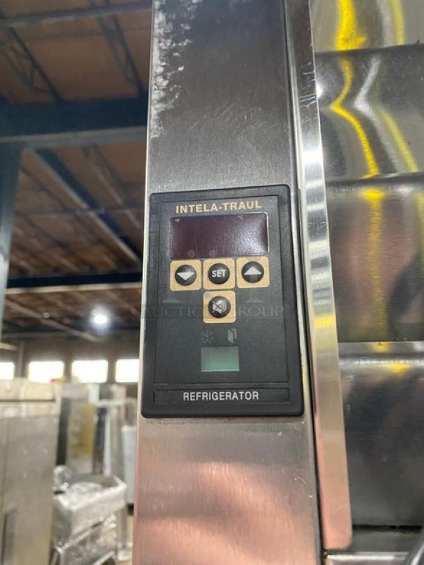 Traulsen RET132EUT-FHS stainless steel refrigerator with digital control panel, adjustable shelving, on casters, model label visible.