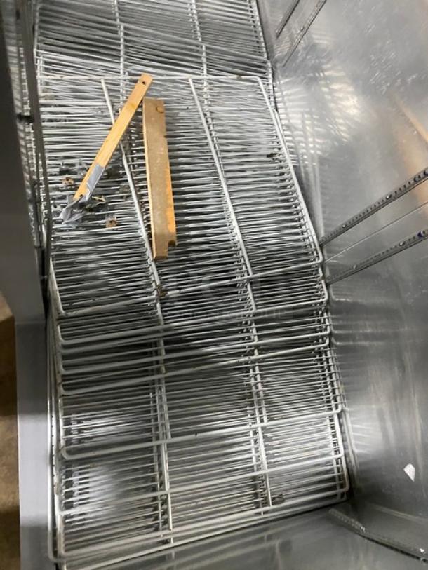 Continental Commercial Stainless Steel 3-Door Freezer interior with poly coated wired rack, Model 3F, on casters.