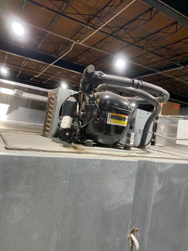 Continental 3F commercial 3-door stainless steel freezer, Energy Star certified, with poly coated rack, on casters, shown with compressor.