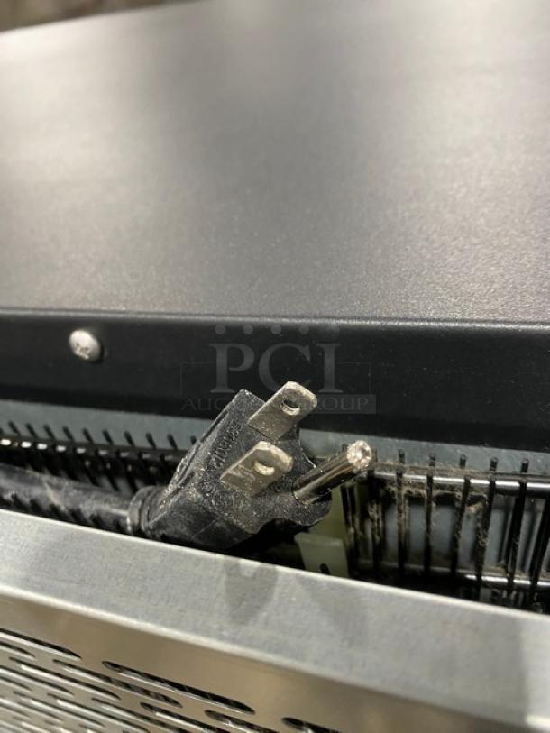 Kool-It KOM36XBK plug and back detail, showing part of the black multi-tier refrigerated merchandiser display case.