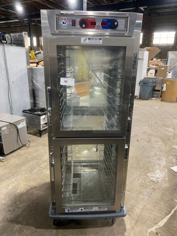 Metro C599SDCUPDC stainless steel glass half-door insulated mobile heated cabinet, built-in pan rack, 120V, on casters.