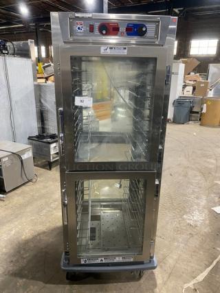 Metro C599SDCUPDC stainless steel glass half-door insulated mobile heated cabinet, built-in pan rack, 120V, on casters.