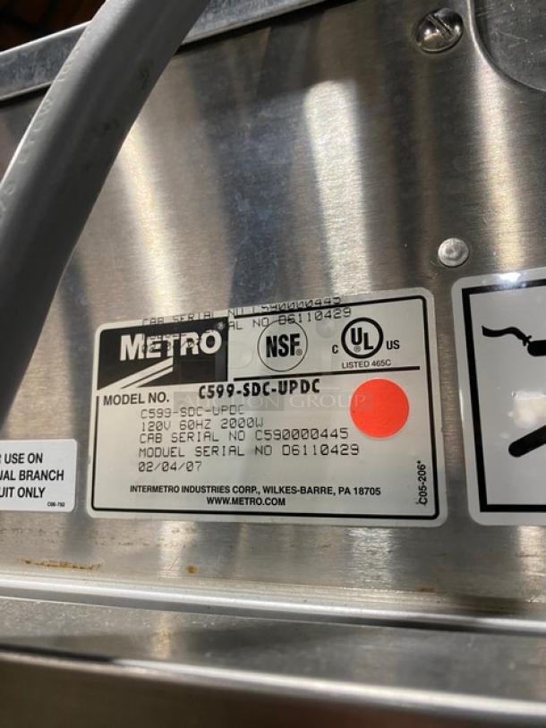 Metro commercial stainless steel heated cabinet, model C599-SDC-UPDC, with glass half door. Features pan holding rack, 120V, on casters.