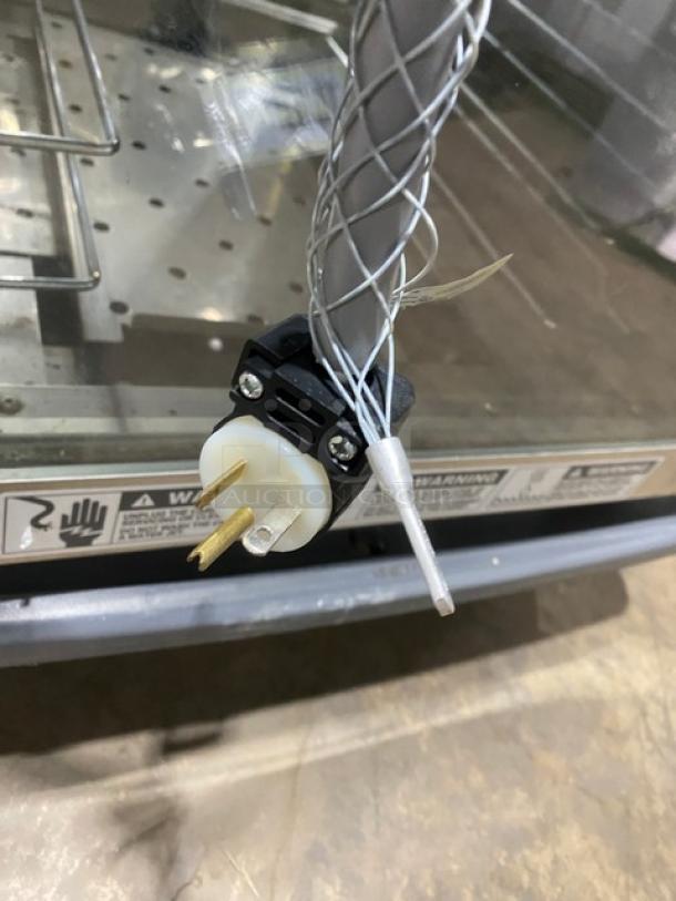 Metro C599-SDC-UPDC insulated cabinet, stainless steel, glass half door, built-in pan rack, 120V, on casters, visible plug.