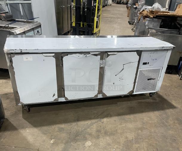 Custom Cool stainless steel 3-door refrigerated worktop table, model LB93SC, on casters, with built-in pan rack, like new.