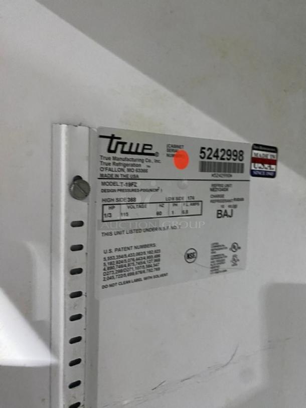 Alt text: True T-19FZ commercial freezer label, model and serial number displayed. 115V, 1 phase, on casters.
