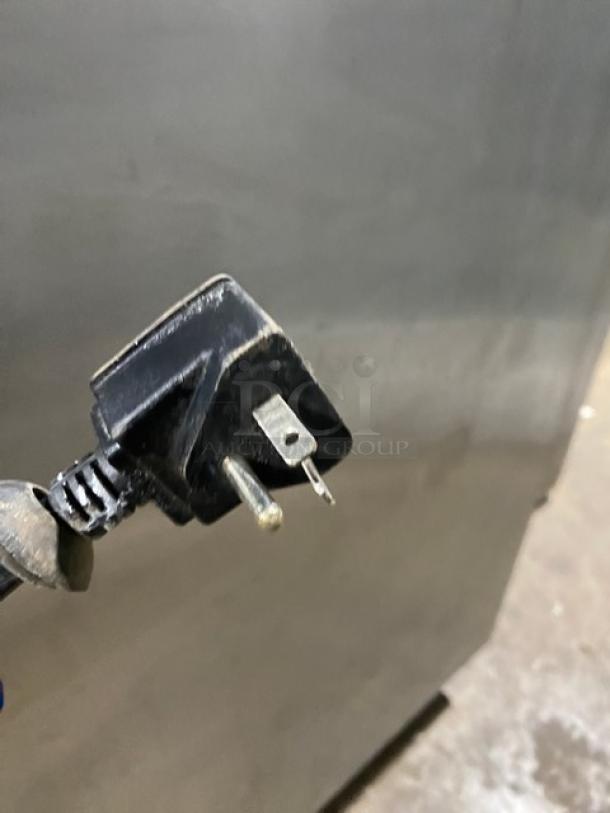 Economy EF2 commercial stainless steel 2-door reach-in freezer, Energy Star, poly coated rack, 115V, on casters, shown with plug.