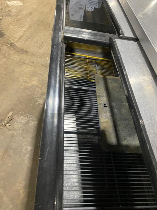 Perlick stainless steel double section back bar cooler, model FR48SS, with double sliding lids and chrome plated rack.