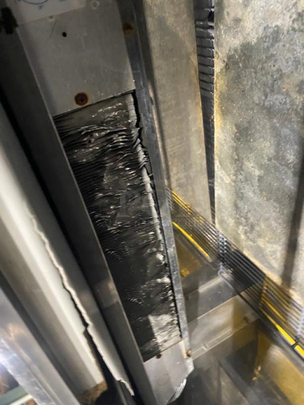 Perlick FR48SS commercial stainless steel back bar bottle cooler with double sliding lids and chrome-plated rack, on casters.