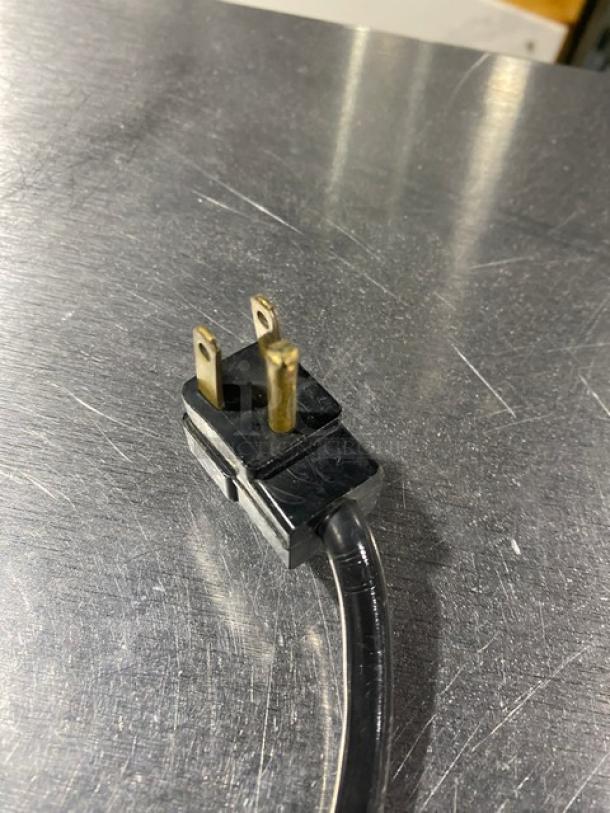 Alt text: Perlick FR48SS power plug on stainless steel surface, showing 115V compatibility.