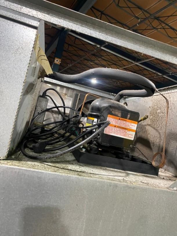 Victory Ultraspec RS2D31 commercial refrigerator top view, showing compressor and wiring. Features stainless steel finish.